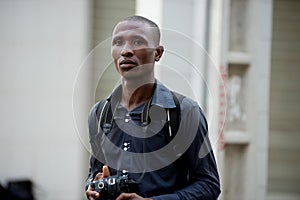 Young tourist photographer walking in the city