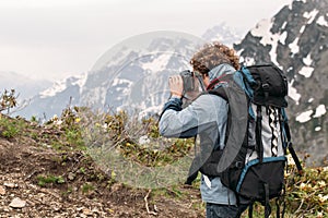 Young tourist photographing the amazing landscape photo