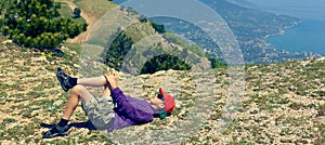 Young tourist resting on top of a hill