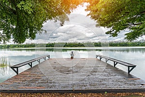 Young tourist sitting on Nong Han Pier. Near the lotus garden in Sakon Nakhon Province,Thailand