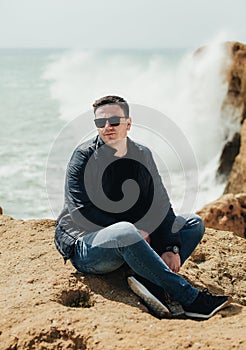 Man sitting on the stone. Travel concept