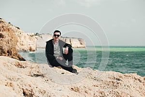 Man sitting on the stone. Travel concept