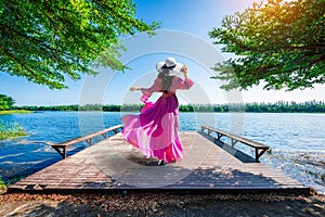 Young tourist stands on Nong Han Pier. Near the lotus garden in Sakon Nakhon Province,Thailand