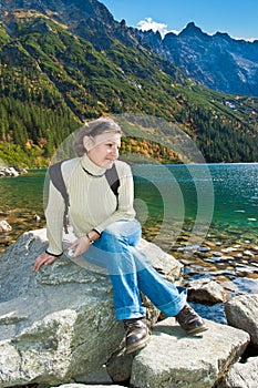 Young tourist on a stone in the Tatry mountains