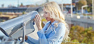 Young tourist using telescope tower observation deck i