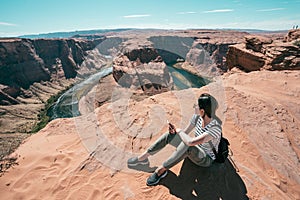 Lady holding cellphone sightseeing the view