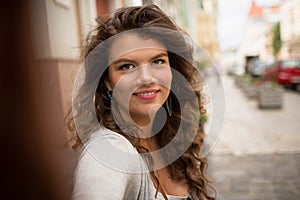 Young tourist woman doing selfie, showing positive emotions.