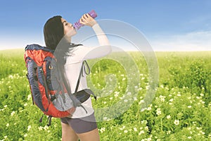 Young tourist woman drinking water