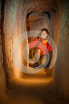 Young tourist woman explore ancient Derinkuyu underground cave city