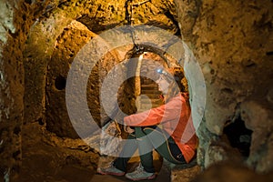 Young tourist woman explore ancient Derinkuyu underground cave city