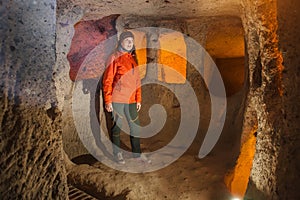 Young tourist woman explore ancient Kaymakli underground cave city