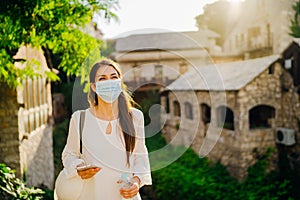 Young tourist woman with face mask travelling to European cities during coronavirus pandemic outbreak. Travel to Europe amid COVID