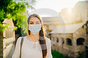 Young tourist woman with face mask travelling to European cities during coronavirus pandemic outbreak. Travel to Europe amid COVID
