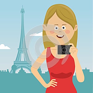 Young tourist woman with film camera stands in Paris in front of Eiffel tower