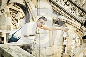 Young tourist woman on the Milan cathedral, Italy