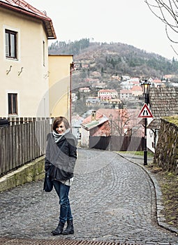 Young tourist woman posing in historical street in Banska Stiavnica