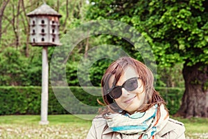 Young tourist woman posing with wooden dovecote