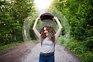 Young tourist woman traveller with backpack walking in nature.