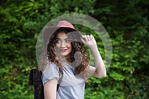 Young tourist woman traveller with backpack walking in nature.