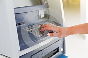 Young tourist woman using banking machine