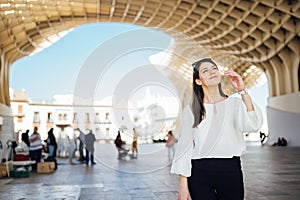 Young tourist woman on vacation in Andalusia, visiting Setas de Sevilla- Metropol Parasol at the La EncarnaciÃ³n square in Seville