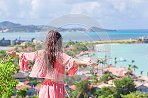 Young tourist woman with view of bay at tropical island in the Caribbean Sea