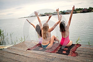 Young tourist women have fun on the dock on lake