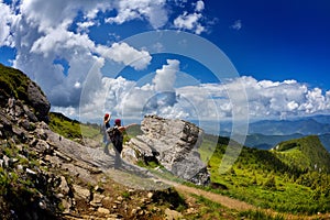 Young tourists with backpacks in mountain zone