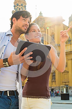 Young Tourists in city with tablet computer