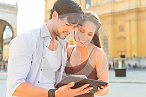 Young Tourists in city with tablet computer