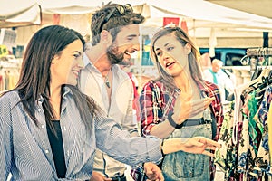 Young tourists at the weekly cloth market - Best friends concept