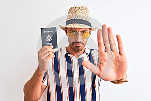 Young tourtist man wearing summer hat and holding USA passport over isolated background with open hand doing stop sign with