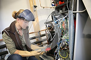 Young trainee verifying electronical installation
