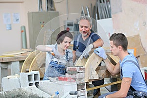 Young trainees learning brick laying