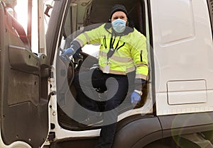 Young transporter on the truck with face mask and protective gloves for Coronavirus