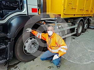 Young transporter on the truck with face mask and protective gloves for Coronavirus