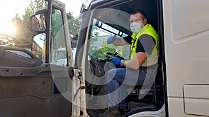 A young transporter on the truck with face mask and protective gloves for Coronavirus