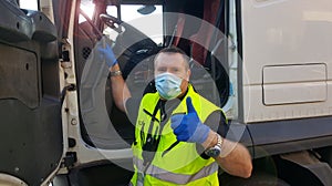 A young transporter on the truck with face mask and protective gloves for Coronavirus