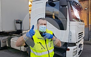 A young transporter on the truck with face mask and protective gloves for Coronavirus