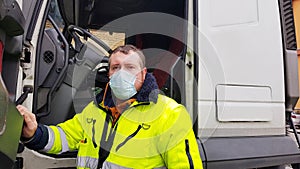 A young transporter on the truck with face mask and protective gloves for Coronavirus