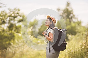 Young travel girl at viewpoint. Hipster girl with backpack. Travel concept. Beautiful woman hiker enjoying amazing landscapes.