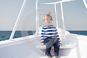 Young traveler. Child cute sailor yacht sunny day. Boy adorable sailor striped shirt white yacht travel around world