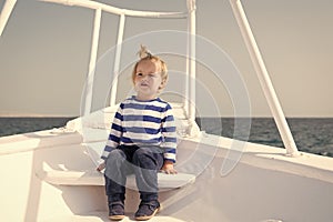 Young traveler. Child cute sailor yacht sunny day. Boy adorable sailor striped shirt white yacht travel around world