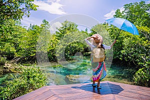 A young traveler girl relax in the holiday enjoying the beauty of nature lake mangrove forest at tha pom-klong-song-nam at krabi.