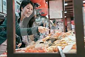 Young traveler hungrily buying street food. photo