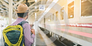 Young traveler man at platform train station. Traveling concept