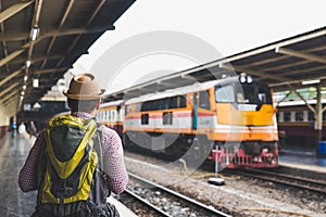 Young traveler man at platform train station. Traveling concept