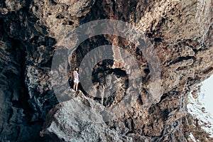 Young traveler man stand on the top of mountain`s cliff