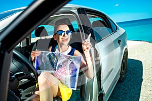 Young traveler with map sitting in the car