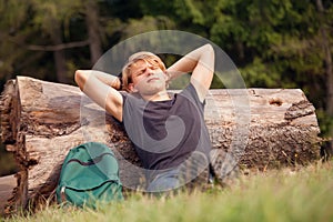 Young traveler rests time at the forest outskirt photo